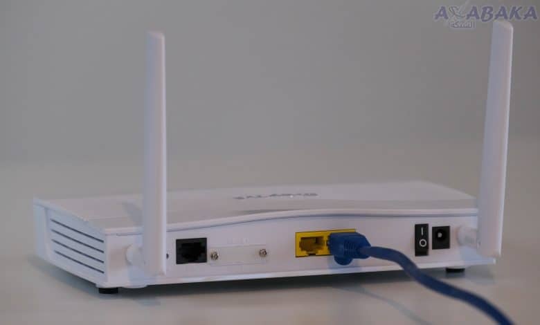 Broadband internet router with ethernet cable plugged in to the back in the ethernet port.