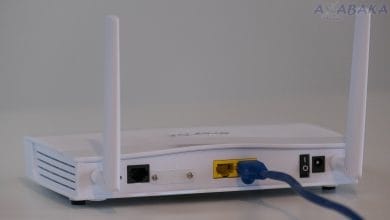 Broadband internet router with ethernet cable plugged in to the back in the ethernet port.